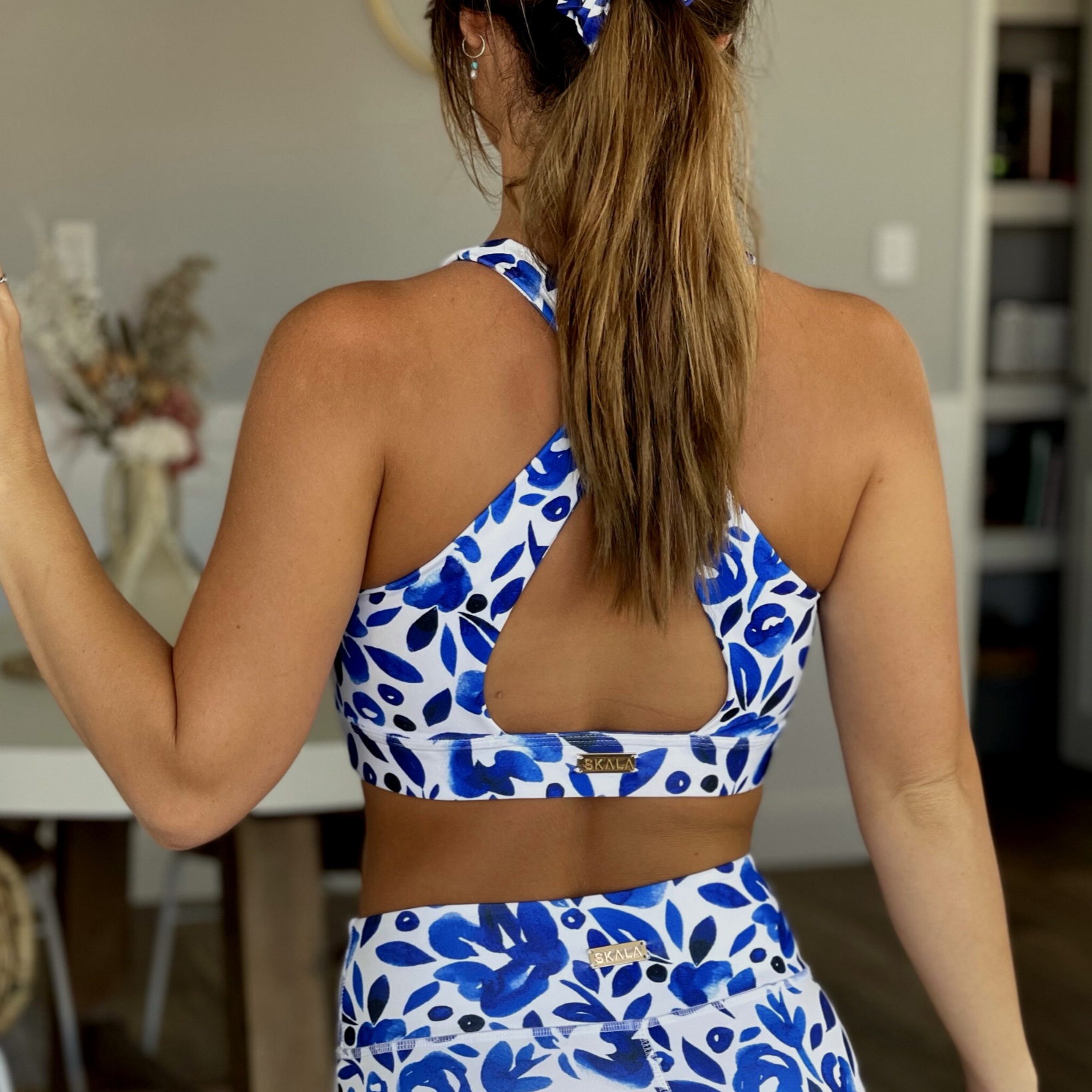 Australian ethical and sustainable activewear matching set made from recycled plastic materials. Blue and white floral sports bra.