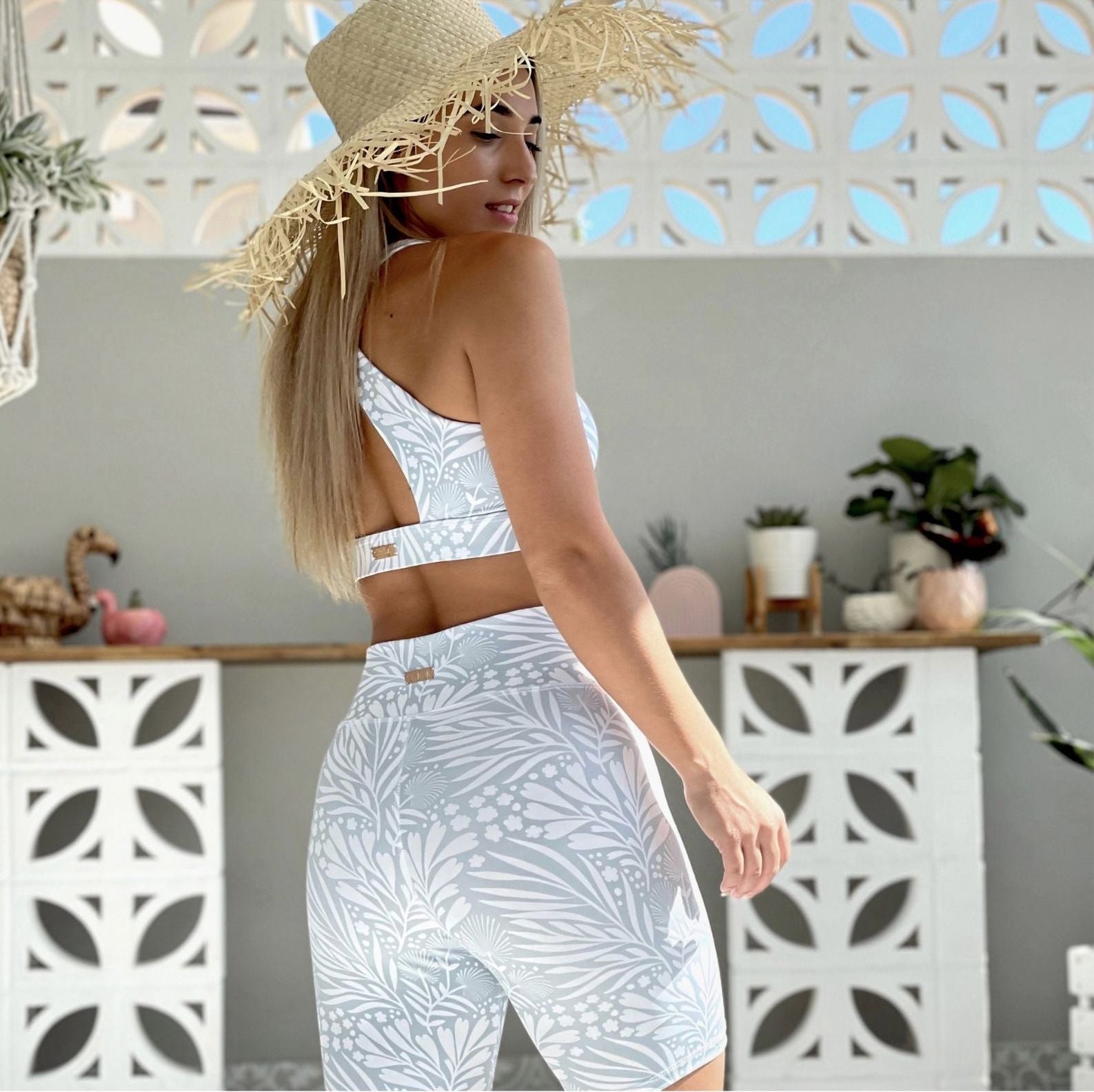 Australian ethical and sustainable activewear matching set made from recycled plastic materials. Light grey and White floral print bike shorts